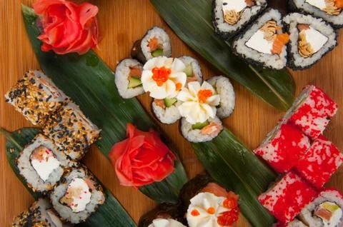 Sushi rolls assorted on a wooden Board concept: delivery Stock Photos