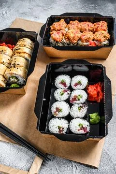 The sushi rolls in the delivery package, ordered in sushi take-out restaurant Stock Photos