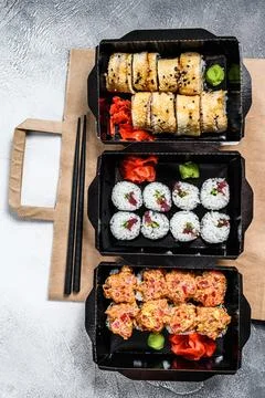 The sushi rolls in the delivery package, ordered in sushi take-out restaurant Stock Photos