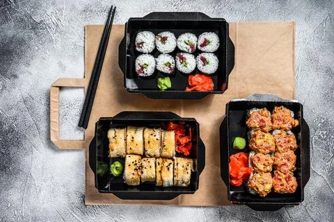 The sushi rolls in the delivery package, ordered in sushi take-out restaurant Stock Photos