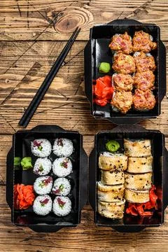 The sushi rolls in the delivery package, ordered in sushi take-out restaurant Stock Photos