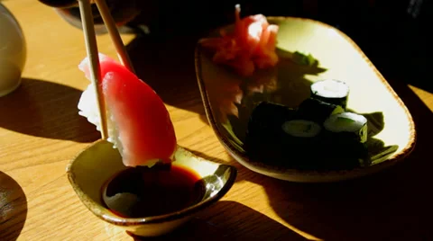 Sushi rolls. Dip sushi roll in the soy sauce. Stock Footage 30398959