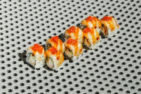 Sushi rolls with eel, shrimp, cucumber and cream cheese, decorated with red.. 写真素材