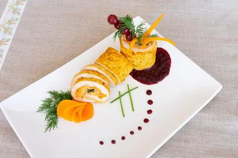 Sushi rolls elegantly presented on a white plate with colorful garnishes Stock Photos