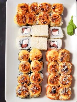 Sushi rolls on a light rectangular plate, isolated background 스톡 사진