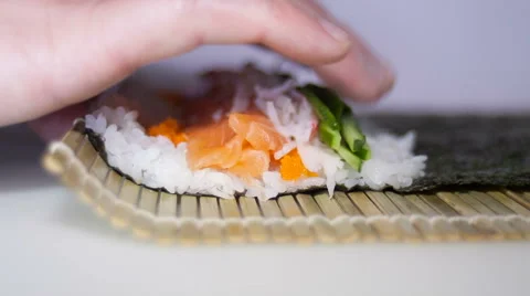 Sushi rolls making process with man's fingers Video stock 68312160