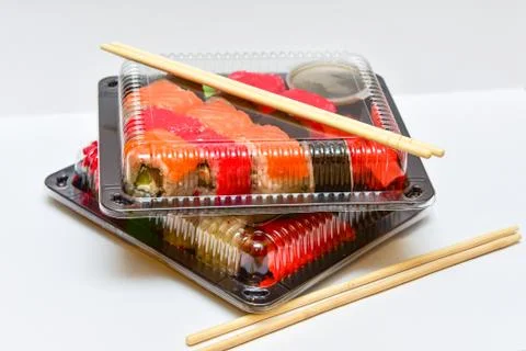 Sushi rolls pack in plastic container on white background Stock Photos