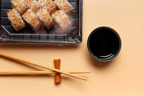 Sushi rolls in a package on a light background. Stock Photos