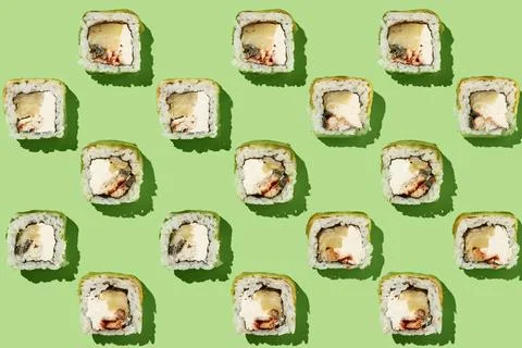 Sushi rolls pattern on mint background. Stock Photos
