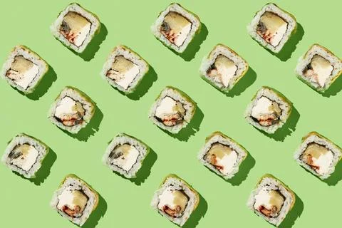 Sushi rolls pattern on mint background. Stock Photos