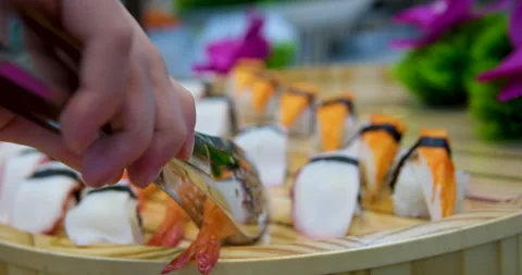 Sushi rolls in a plastic box rotate close-up on black background. Ready-to-eat Stock Footage 277302768