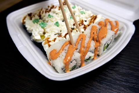 Sushi rolls in a plastic container Stock Photos
