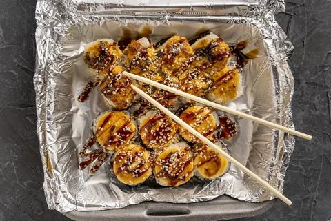 Sushi rolls in a plastic thermo container. Takeaway food 库存照片