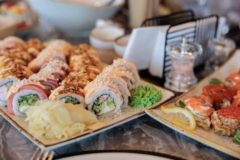 Sushi rolls on a plate on restaurant table Stock Photos