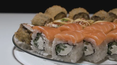 Sushi rolls on a plate side view camera moves from left to right slowmotion Stock Footage 108009519