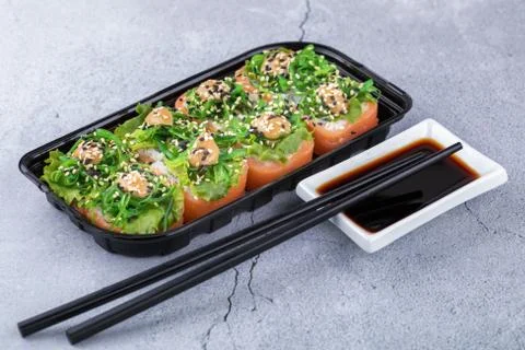 Sushi rolls with seafood and Chuka salad. Green sushi. Top view. Free space for Stock Photos