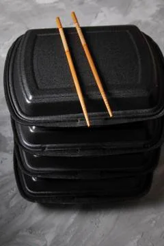 Sushi rolls set on dark table, food chopsticks. Vertical photo Stock Photos
