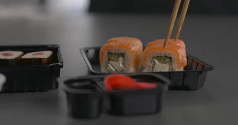 Sushi rolls set on table serving with pickled ginger and soy sauce. Stock Footage 152940554