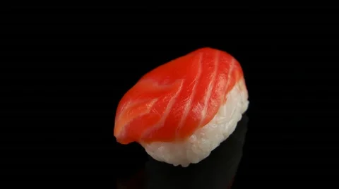 Sushi with salmon on black background rotating (loop) Stock Footage 55640090