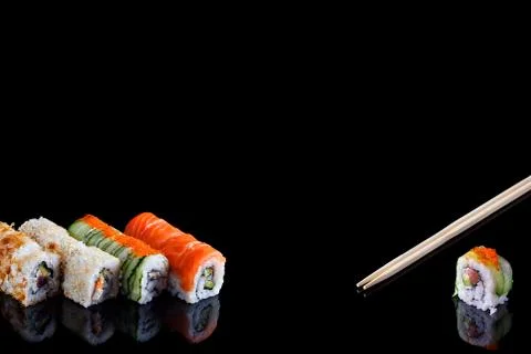 Sushi set and chopsticks on black background with copy space Stock Photos