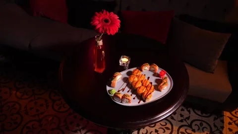 Sushi set of baked rolls on table in restaurant Stockbeeldmateriaal 269548660