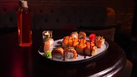 Sushi set of baked rolls on table in restaurant Stock Footage 269548732
