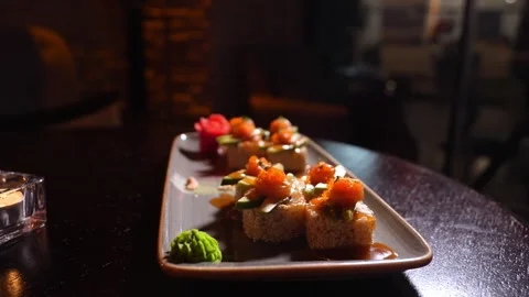 Sushi set of baked rolls on table in restaurant Stock Footage 269558874