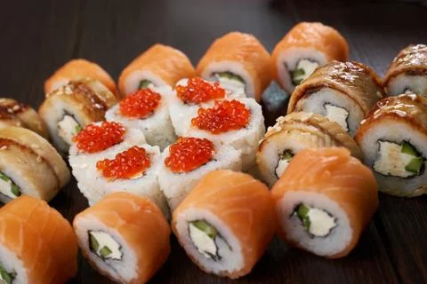Sushi set on a dark brown table Stock Photos