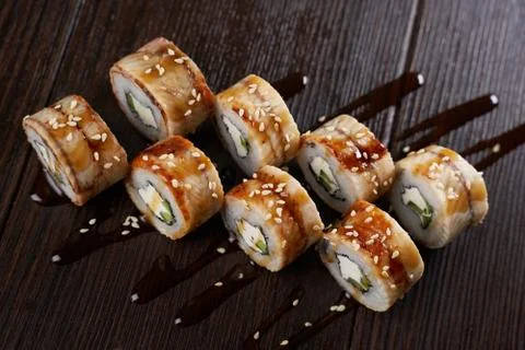 Sushi set on a dark brown table Stock Photos