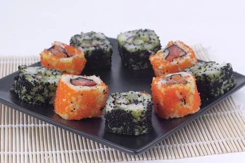Sushi Set - different types of Maki sushi and chopsticks on a b Stock Photos