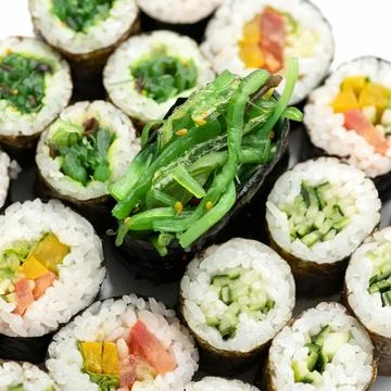 Sushi Set. Different types of sushi rolls and sashimi with seaweed in center Stock Photos