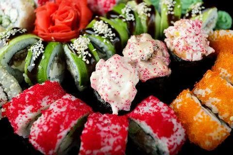Sushi set of various sushi rolls on a black background Stock Photos