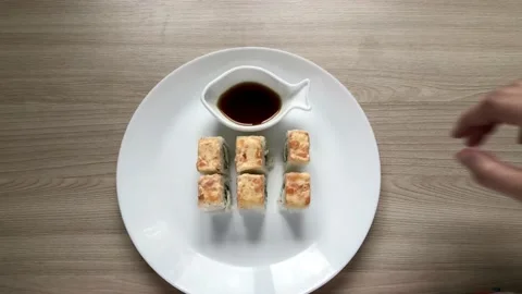 Sushi set on a white plate. From different sides take sushi from a plate Stock Footage 131744969