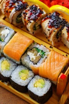 Sushi sets of different types of sushi are cured for serving in a restaurant. Stock Photos