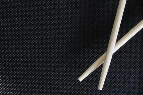 Sushi sticks on a black background with an empty space. The concept of food Stock Photos