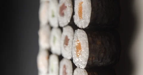 Sushis rotating close ups on black background 4K, vertical view Stock Footage 260137588
