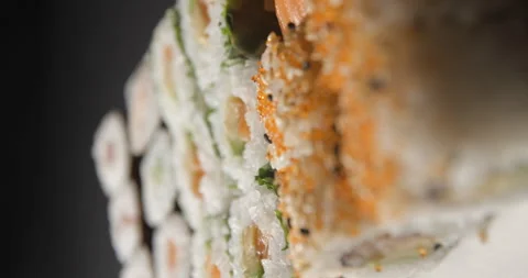 Sushis rotating close ups on black background 4K, vertical view Stock Footage 260137700