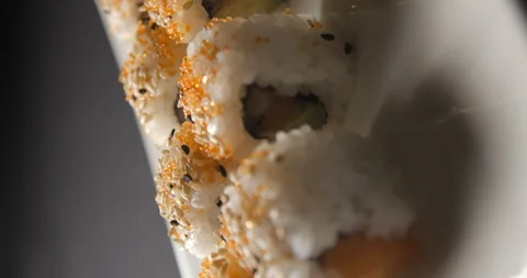 Sushis rotating close ups on black background 4K, vertical view Video stock 260138147