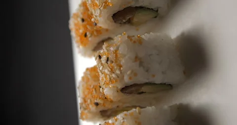 Sushis rotating close ups on black background 4K, vertical view Video stock 260138210