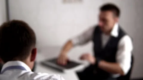 Suspect gives a folder to detective and he reads it and turns pages Stock Footage 133087723