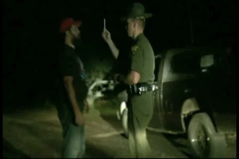 Suspected drunk driver being tested by police officer Stock Footage 8691901