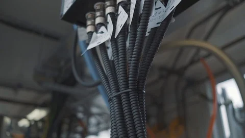 Suspended bundle of cables ready for work in an industrial factory premises Stock Footage 125881048
