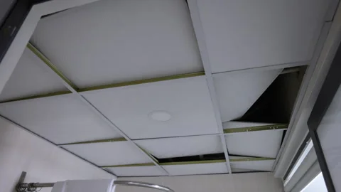 Suspended ceiling tiles drastically lifting Stock Footage 338339742
