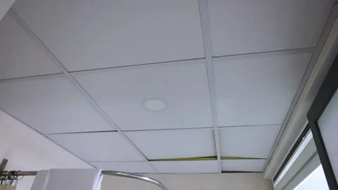 Suspended ceiling tiles moving up and down due to strong ventilation draft Video stock 338340103