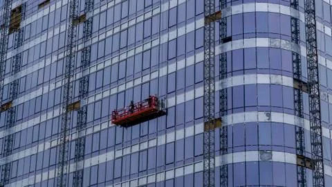 Suspended construction cradle on the background facade of the building. Mobil Stock Photos
