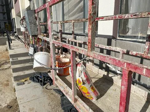 Suspended construction cradle on the background facade of the building. Mobil Stock Photos