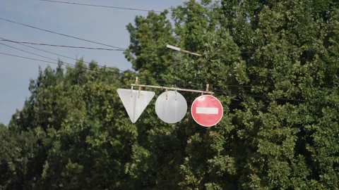 Suspended do not enter traffic sign, hanging from a wire against a cloudy sky Stock-Footage 345705659