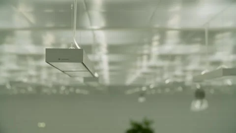 Suspended Modern Ceiling Lights Illuminating Office Interior With Minimalist Stock Footage 334541700