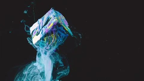 Suspended paint-coated cube releasing translucent smoke plume against black back Stock-Footage 341464526