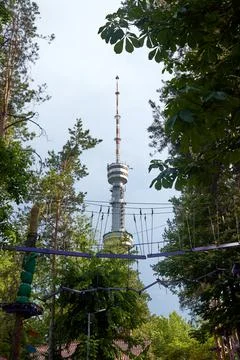 Suspended path of the rope park on the background of the TV tower Stock Photos